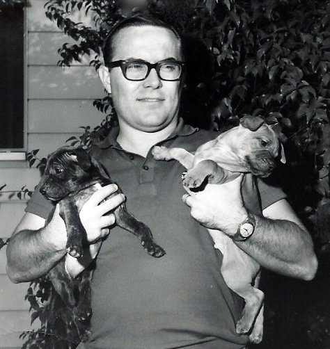 Steve holding two pups
